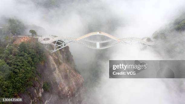 Cloud-shrouded Ruyi Bridge is seen at Shenxianju Scenic Area on March 9, 2021 in Taizhou, Zhejiang Province of China.