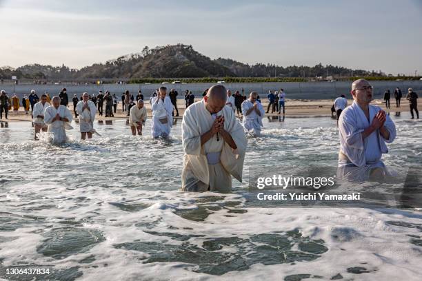 Buddhist monks pray for the victims of the 2011 Tohoku earthquake and tsunami at a beach on March 11, 2021 in Iwaki, Japan. Japan will today observe...