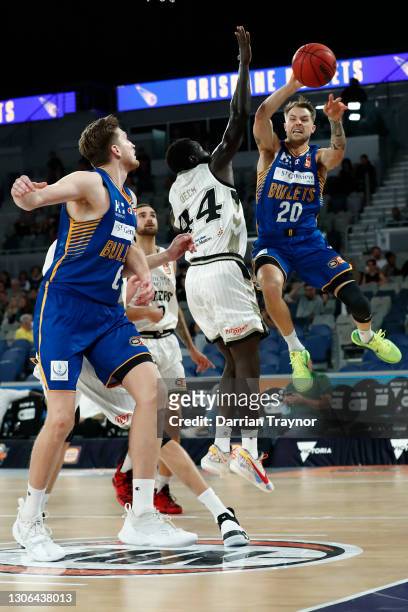 Nathan Sobey of the Bullets dishes off during the NBL Cup match between the Brisbane Bullets and the Adelaide 36ers at John Cain Arena on March 11 in...