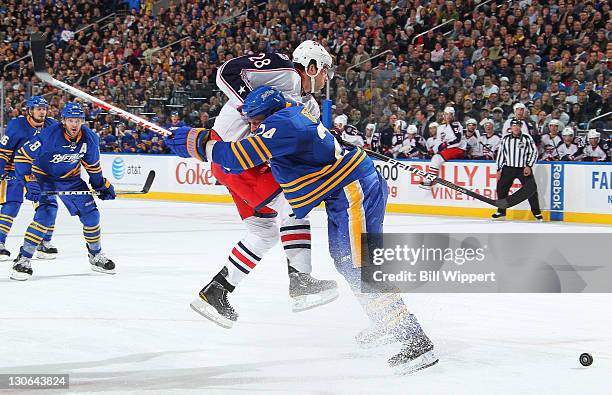 Robyn Regehr of the Buffalo Sabres blocks the path of Alexandre Giroux of the Columbus Blue Jackets at First Niagara Center on October 27, 2011 in...