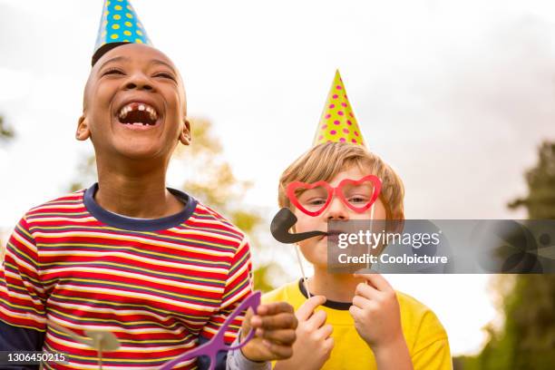 multiethnic group of children having party. - funky boy stock pictures, royalty-free photos & images