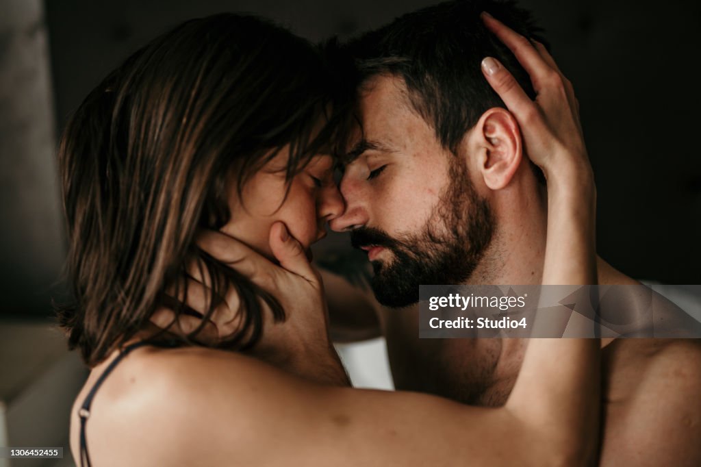 Close up image of a couple in bed with eyes closed