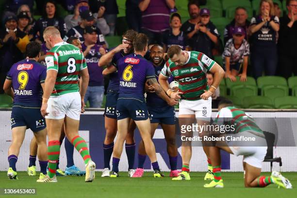Justin Olam of the Storm celebrates with team mates after scoring a try during the round one NRL match between the Melbourne Storm and the South...