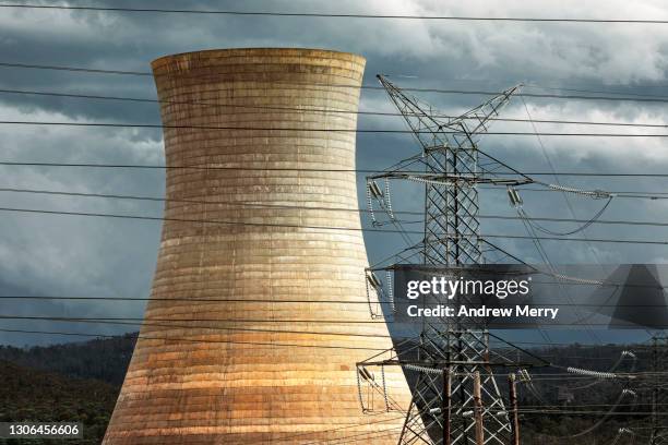 global warming, power station tower, electricity pylon and storm clouds - nuclear fission stock pictures, royalty-free photos & images