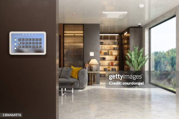 smart home control system med appikoner på en digital skärm i vardagsrummet med suddig bakgrund. - domotic bildbanksfoton och bilder