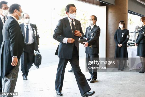 Japanese Finance Minister Taro Aso wearing a face mask arrives at the National Theatre of Japan to attend the national memorial service for the...