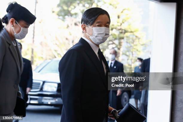 Japanese Emperor Naruhito and Empress Masako wearing face masks arrive at the National Theatre of Japan to attend the national memorial service for...