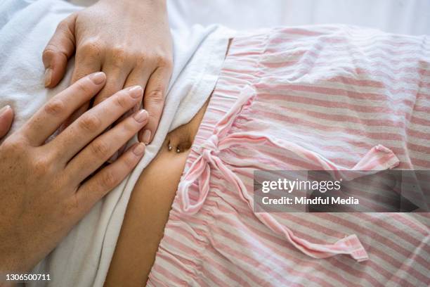 close-up of female hands on belly - belly button stock pictures, royalty-free photos & images