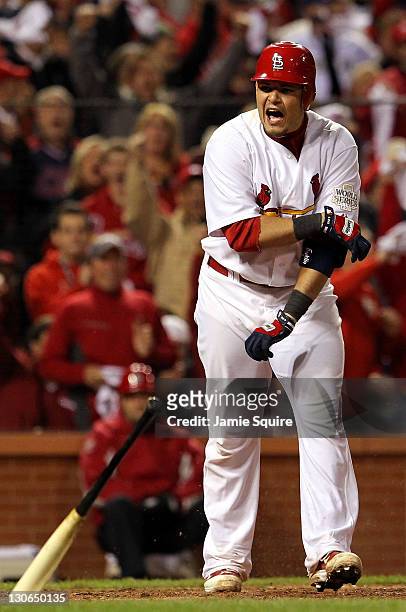 Yadier Molina of the St. Louis Cardinals reacts after drawing a walk with the bases loaded to score Lance Berkman in the sixth inning during Game Six...