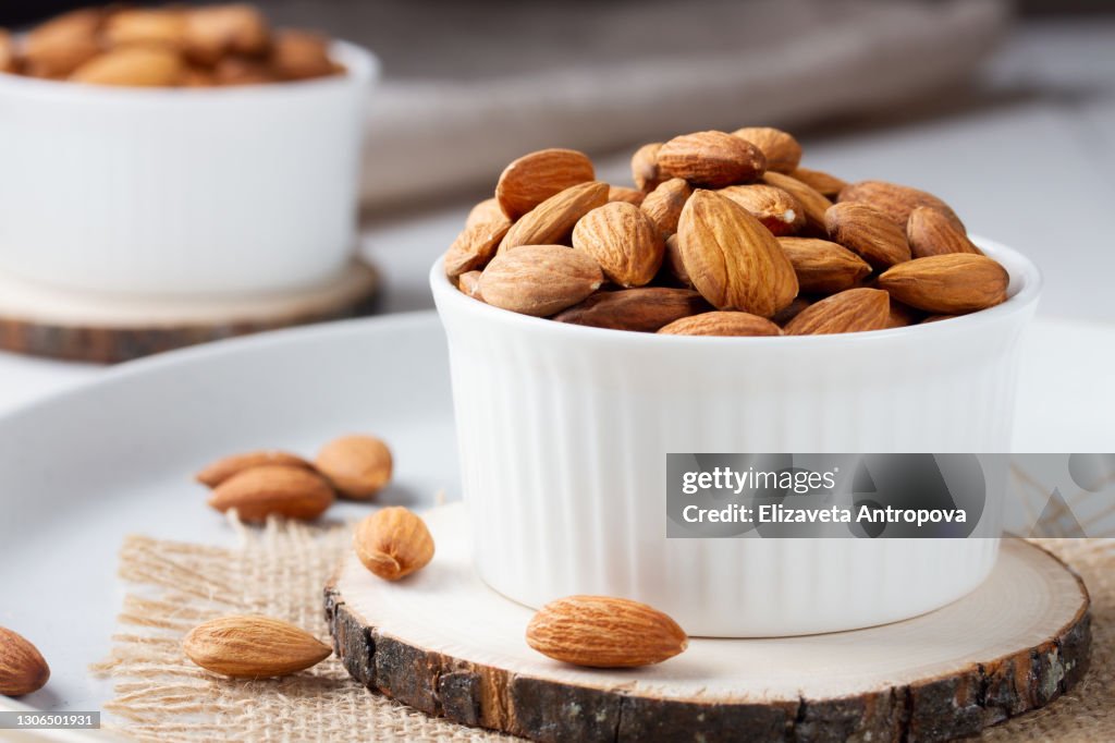 Full bowl of almond nuts, rustic style