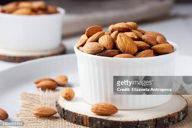 full bowl of almond nuts, rustic style - mandel stock-fotos und bilder