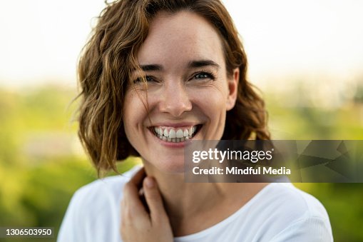 Portrait of smiling woman while standing outdoors Portrait of smiling woman while standing outdoors