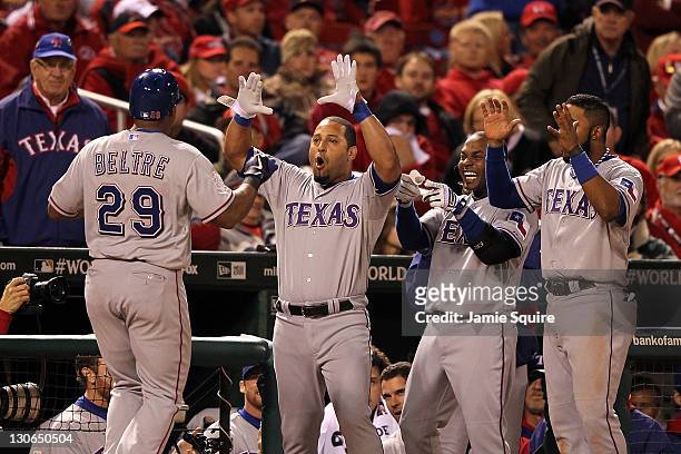 Adrian Beltre of the Texas Rangers celebrates with Yorvit Torrealba after hitting a solo home run in the seventh inning during Game Six of the MLB...