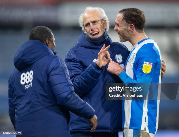 Cardiff City manager Mick McCarthy and assistant manager Terry Connor with Richard Keogh of Huddersfield Town during the Sky Bet Championship match...