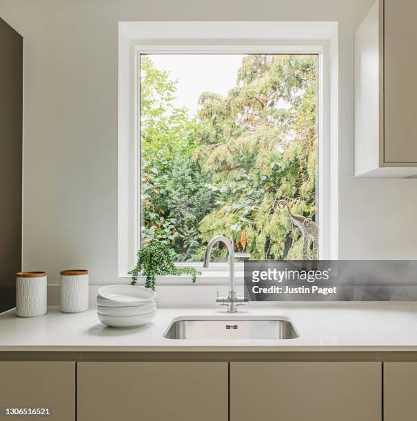 kitchen sink with a nature view - fenster stock-fotos und bilder