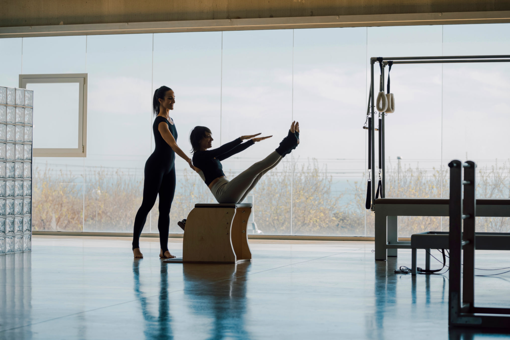 Personal trainer correcting posture, helping the client with exercises. Personal trainer correcting posture, helping the client with exercises.