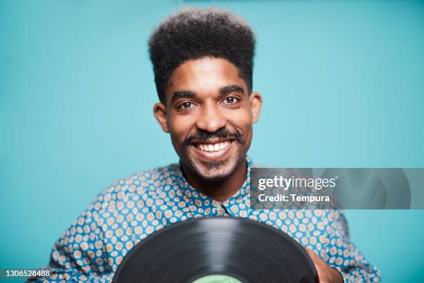 jazz musician holding a long play record - black dj stock pictures, royalty-free photos & images
