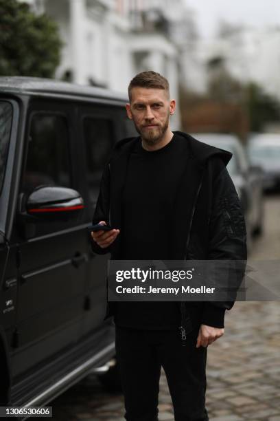 Aaron Hunt wearing black sweater, black oversized jacket and black denim on March 06, 2021 in Hamburg, Germany.