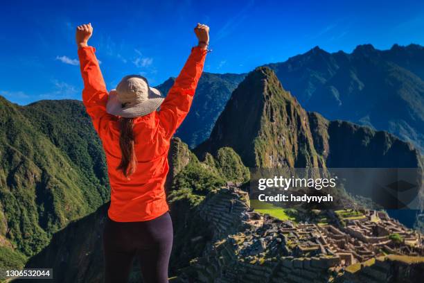 female tourist looking at machu picchu - hiking machu picchu stock pictures, royalty-free photos & images