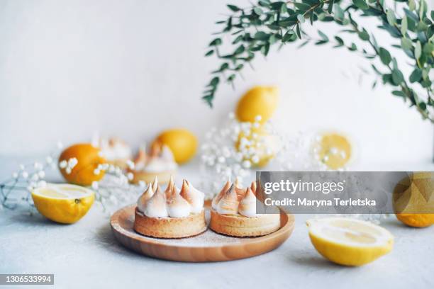 delicious cute lemon tarts on a white background. - meringe stock-fotos und bilder