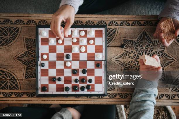 playing chess and eating cracker - chess board overhead stock pictures, royalty-free photos & images