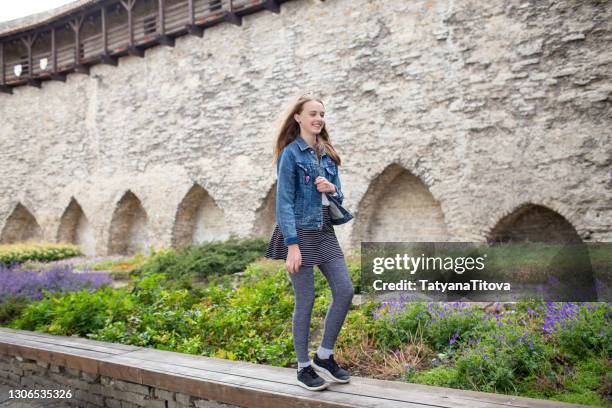 portrait of a teenage girl against a stone wall, tallinn, kohtuotsa - tallinn stock pictures, royalty-free photos & images