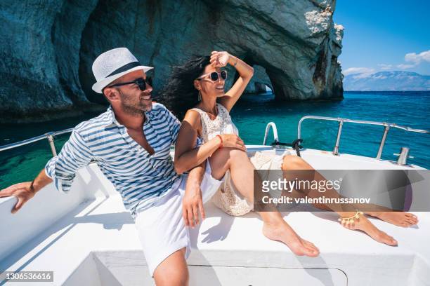 couple in love enjoying summer vacations on a yacht in zakynthos greece - navagio beach and having fun traveling again during coronavirus outbreak - greece stock pictures, royalty-free photos & images