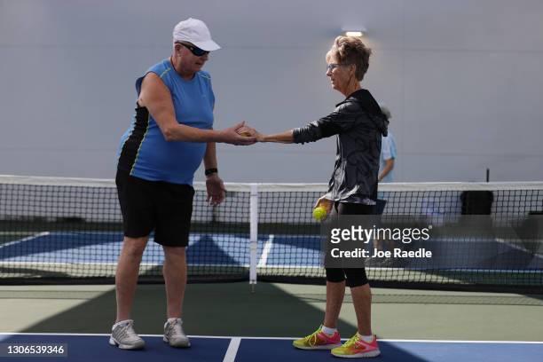 Lance Shaw and Cecilia Dehlin along with others vaccinated against COVID-19, learn the pickleball game at the John Knox Village Continuing Care...