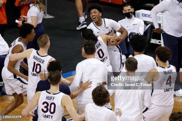 Reece Beekman of the Virginia Cavaliers reacts with his team after hitting the game-winning three point basket as time expired on the clock during...