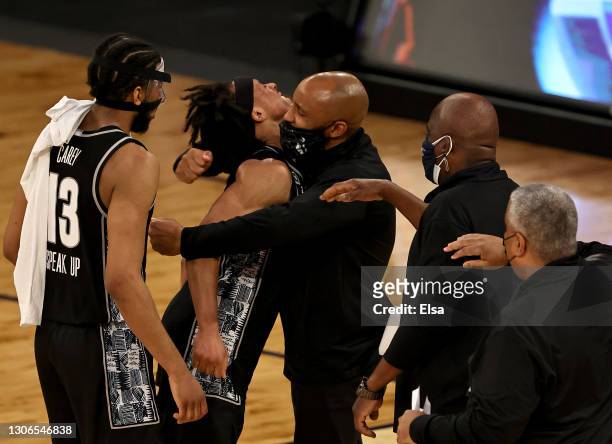 Dante Harris and Donald Carey of the Georgetown Hoyas celebrate the win with members of the coaching staff during the Quarterfinals of the Big East...