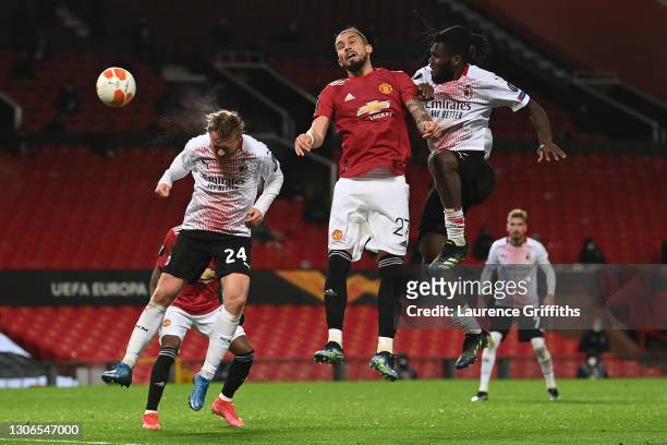 Simon Kjaer of A.C. Milan scores their team's first goal under pressure from Alex Telles of Manchester United during the UEFA Europa League Round of...