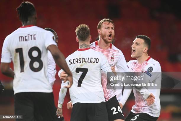 Simon Kjaer of A.C. Milan celebrates with teammates Samu Castillejo and Diogo Dalot after scoring their team's first goal during the UEFA Europa...