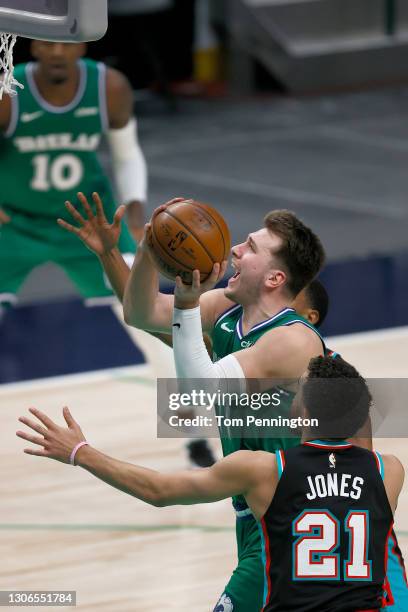 Luka Doncic of the Dallas Mavericks drives to the basket against Tyus Jones of the Memphis Grizzlies in the second half at American Airlines Center...