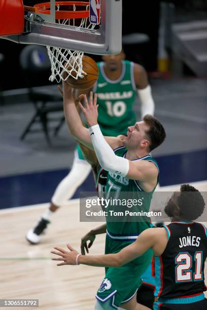 Luka Doncic of the Dallas Mavericks drives to the basket against Tyus Jones of the Memphis Grizzlies in the second half at American Airlines Center...