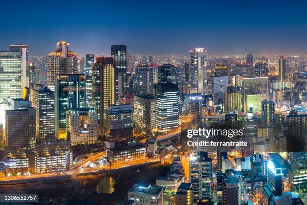 illuminated osaka skyline at dusk - japan skyline stock pictures, royalty-free photos & images