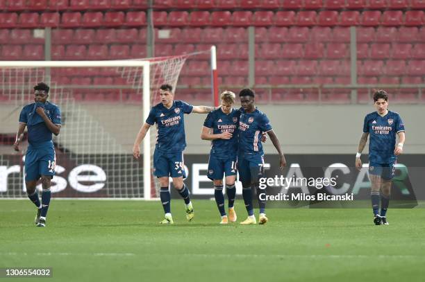 Martin Odegaard of Arsenal celebrates with team mates Granit Xhaka and Bukayo Saka after scoring their side's first goal during the UEFA Europa...