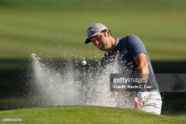 Jon Rahm of Spain plays a shot from a bunker on the ninth hole during the first round of THE PLAYERS Championship on THE PLAYERS Stadium Course at...