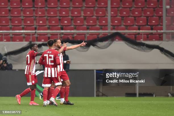 Youssef El-Arabi of Olympiacos FC celebrates with teammates Bruma and Kenny Lala after scoring their team's first goal during the UEFA Europa League...