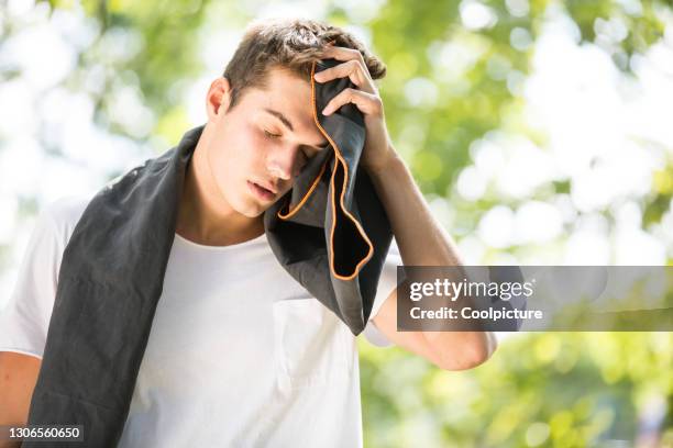 young man exercising - jogging. - hitzewelle stock-fotos und bilder