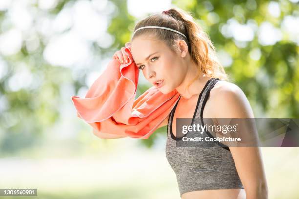 young woman exercising - break after jogging. - heat exhaustion stock pictures, royalty-free photos & images