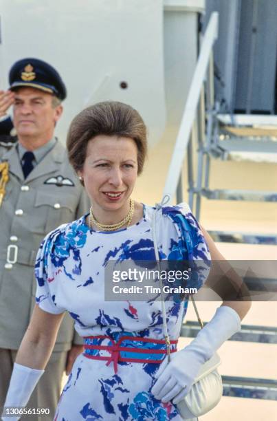 British Royal Princess Anne, Princess Royal wearing a blue and white print pattern dress with red detail, a red belt and white evening gloves during...