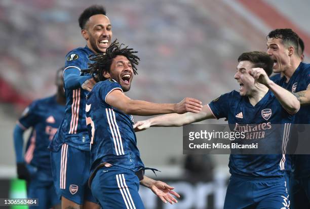 Mohamed Elneny of Arsenal celebrates with team mates Kieran Tierney and Pierre-Emerick Aubameyang after scoring their side's third goal during the...