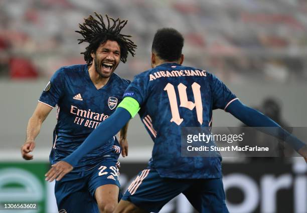 Mo Elneny celebrates scoring the 3rd Arsenal goal with Pierre-Emerick Aubameyang during the UEFA Europa League Round of 16 First Leg match between...