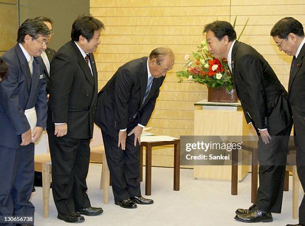 Nago City Mayor Susumu Inamine , Kin Town Mayor Tsuyoshi Gibu and Okinawa governor Hirokazu Nakaima greet Prime minister Yoshihiko Noda at Noda's...