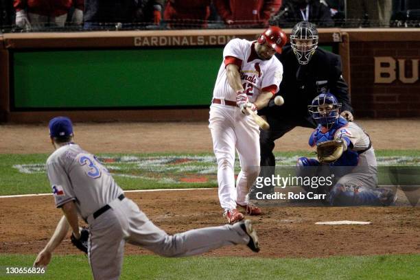 Lance Berkman of the St. Louis Cardinals hits an RBI single to tie the game in the 10th inning off of Scott Feldman of the Texas Rangers during Game...