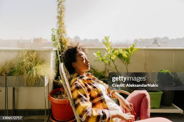 relaxing in my rooftop garden - sunbathing stock pictures, royalty-free photos & images