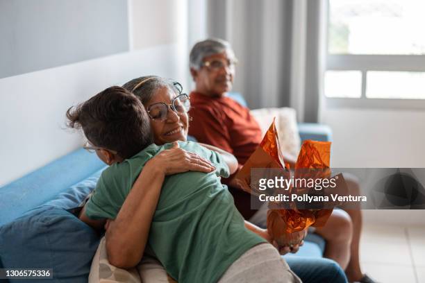 boy hugging his grandmother at easter - happy easter stock pictures, royalty-free photos & images