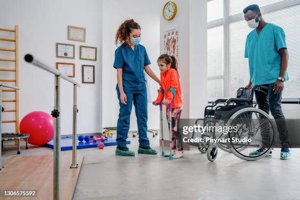 young patient doing physiotherapy at a clinic with help of a therapists - orthopaedic equipment imagens e fotografias de stock