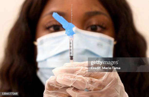 Dose of the new one-shot Johnson & Johnson COVID-19 vaccine is prepared at a vaccination event at Baldwin Hills Crenshaw Plaza in South Los Angeles...