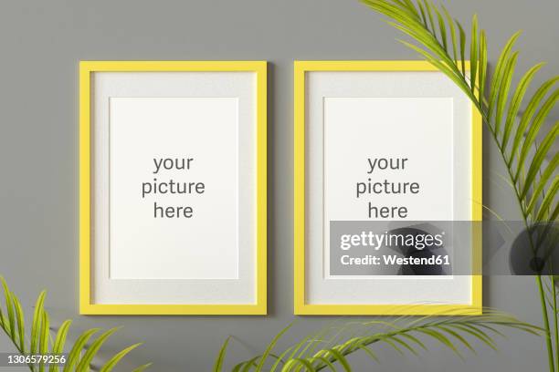 three dimensional render of two picture frames with placeholder text hanging on gray wall - side by side stock illustrations
